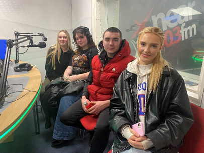 Four young people in the Near FM recording studio 